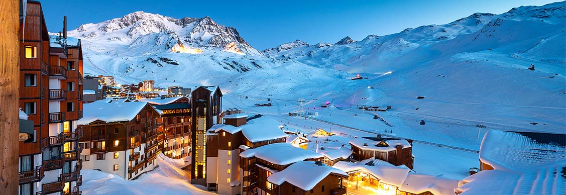 Panorama of snowy mountains and hotels in a French Alps ski resort